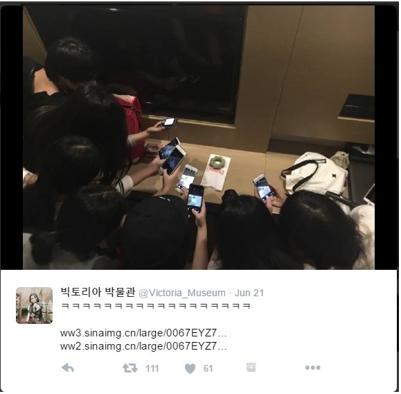 Fans taking photo of the doughnut Victoria gave.