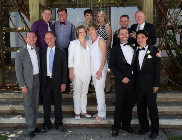 Newly married gay and lesbian couples pose for a photograph at Canberra's Old Parliament House on December 7, 2013. (front L-R) Joel Player and Alan Wright, Samantha Hermes and Hayley Wilson and Ivan Hinton and Chris Teoh. (back L-R) Craig Berry and Ulises Garcia, Narell Majic and Ashleigh Watson and Stephen Dawson and Dennis Littelow.