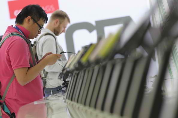 Visitors look at Acer W4 smartphones at the Acer stand at the IFA 2011 consumer technology trade fair on the first day of the fair's official opening on September 2, 2011 in Berlin, Germany.