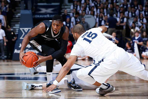 Kris Dunn #3 of the Providence Friars gets a loose ball ahead of Myles Davis #15 of the Xavier Musketeers in the first half of the game at Cintas Center on February 17, 2016 in Cincinnati, Ohio. 