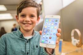 Levi aged 10, shows of the new iPhone 6s Plus in rose gold as crowds wait in anticipation for the release of the iPhone 6s and 6s Plus at Apple Store on September 25, 2015 in Sydney, Australia. 
