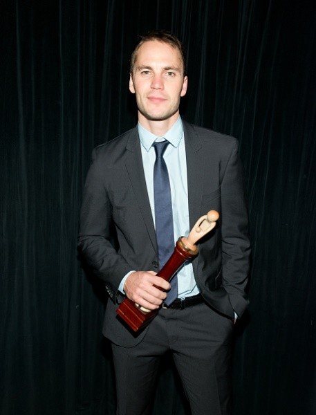 Actor Taylor Kitsch posed with his ChangeMakers Award during the 6th Annual African Children's Choir Changemakers Gala at City Winery on November 20, 2014 in New York City.
