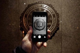 The official seal of the Federal Bureau of Investigation is seen on an iPhone's camera screen outside the J. Edgar Hoover headquarters