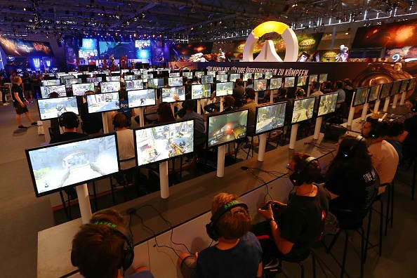 Visitors try out Blizzard at the Gamescom 2016 gaming trade fair during the media day on August 17, 2016 in Cologne, Germany.