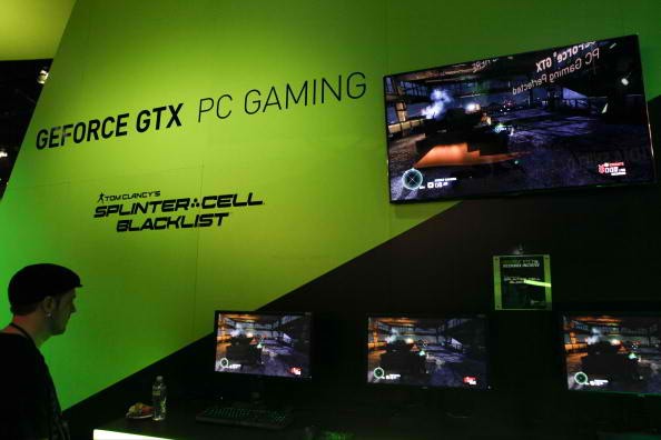 A booth attendant plays UbiSoft Entertainment SA's Tom Clancy's Splinter Cell: Blacklist video game at the Nvidia Corp.