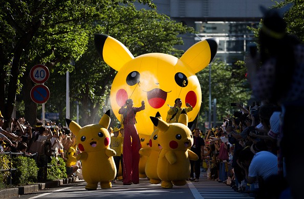 Performers dressed as Pikachu, a character from Pokemon series game titles, march during the Pikachu Outbreak event hosted by The Pokemon Co. on August 7, 2016 in Yokohama, Japan. 
