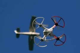  A drone is flown for recreational purposes as an airplane passes nearby in the sky above Old Bethpage, New York on September 5, 2015.
