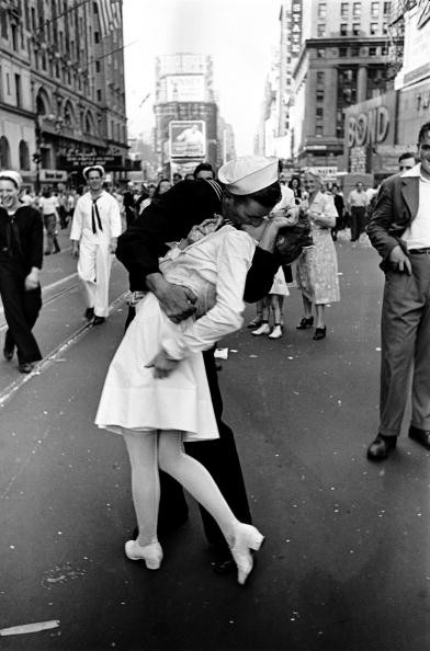 Happy sailor kissing nurse in Times Square during impromptu VJ Day celebration following announcement of the Japanese surrender and the end of WWII.