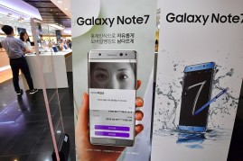 Signboards of the Samsung Galaxy Note7 are displayed at an entrance of a Samsung showroom in Seoul on September 2, 2016. Samsung will suspend sales of its latest high-end smartphone Galaxy Note 7 after reports of exploding batteries, its mobile chief said
