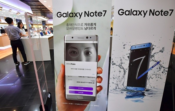 Signboards of the Samsung Galaxy Note7 are displayed at an entrance of a Samsung showroom in Seoul on September 2, 2016. Samsung will suspend sales of its latest high-end smartphone Galaxy Note 7 after reports of exploding batteries, its mobile chief said