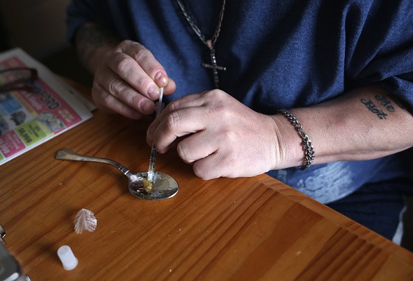 A heroin user prepares to inject himself on March 23, 2016 in New London, CT. 