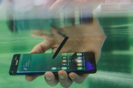 A visitor tests the waterproof S7 from Samsung at the 2016 IFA consumer electronics trade fair in Berlin, Germany.