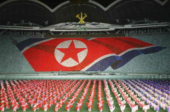 North Koreans perform showing North Korean national flag during the Arirang festival which is a part of commemorations marking the 60th anniversary of the Workers' Party of North Korea on October 6, 2005 in PyongYang, North Korea. 