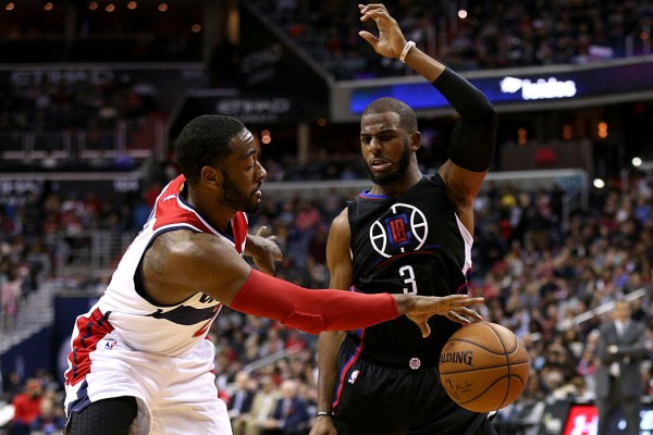 Washington Wizards point guard John Wall (L) competes for the ball against Los Angeles Clippers' Chris Paul