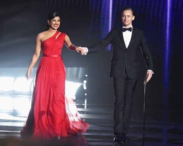 Actors Priyanka Chopra and Tom Hiddleston walk onstage during the 68th Annual Primetime Emmy Awards at Microsoft Theater on Sept. 18 in Los Angeles, California.