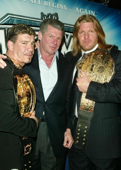 Wrestler Eddie Guerrero, WWE Chairman Vince McMahon and Wrestler Triple H attend a press conference to promote Wrestlemania XX at Planet Hollywood March 11, 2004 in New York City. 