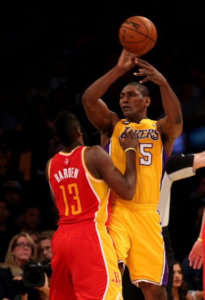 Metta World Peace of the Los Angeles Lakers throws a pass over James Harden #13 of the Houston Rockets at Staples Center on April 17, 2013 in Los Angeles, California. 
