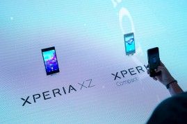A visitor uses a smartphone device to take a photograph of the Xperia XZ, left, and an Xperia X compact smartphones during a news conference on the Sony Corp. exhibition stand during the IFA International Consumer Electronics Show in Berlin, Germany, on T