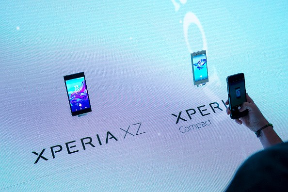 A visitor uses a smartphone device to take a photograph of the Xperia XZ, left, and an Xperia X compact smartphones during a news conference on the Sony Corp. exhibition stand during the IFA International Consumer Electronics Show in Berlin, Germany, on T
