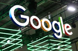The Google Inc. logo hangs illuminated over the company's exhibition stand at the Dmexco digital marketing conference in Cologne, Germany, on Wednesday, Sept. 14, 2016.