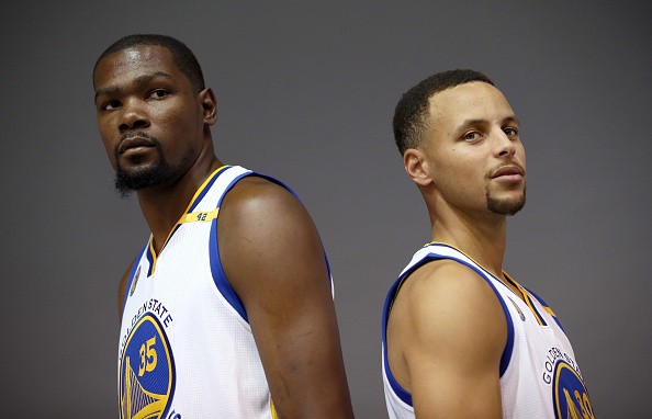 Kevin Durant and Stephen Curry of the Golden State Warriors pose for San Francisco Chronicle photographer Russell Yip during the Golden State Warriors Media Day at the Warriors Practice Facility on September 26, 2016 in Oakland, California. 