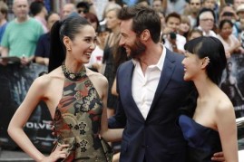 Actor Hugh Jackman poses with Tao Okamoto (L) and Rila Fukushima (R) at the UK Premiere of 'The Wolverine' at Leicester Square in London July 16, 2013.