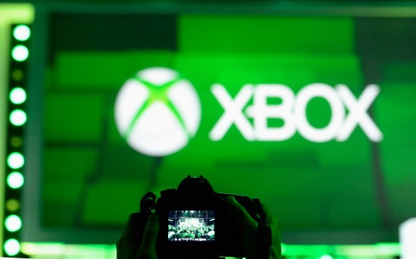 An attendee takes a photo of the XBOX logo during the Microsoft Xbox news conference at the Electronic Entertainment Expo at the Galen Center on June 10, 2013 in Los Angeles, California