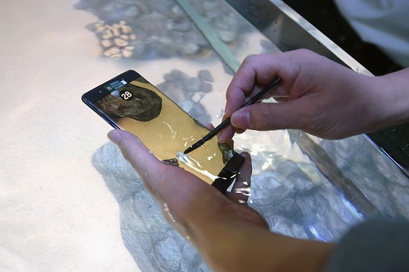 Consumers experience the water resistance of the new Samsung Galaxy Note 7 during Samsung Unpacked 2016 at Hammerstein Ballroom on August 2, 2016 in New York City.