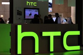 Logos sit illuminated at the HTC Corp. pavilion during the Mobile World Congress at the Fira Gran Via complex in Barcelona, Spain on February 27, 2014.