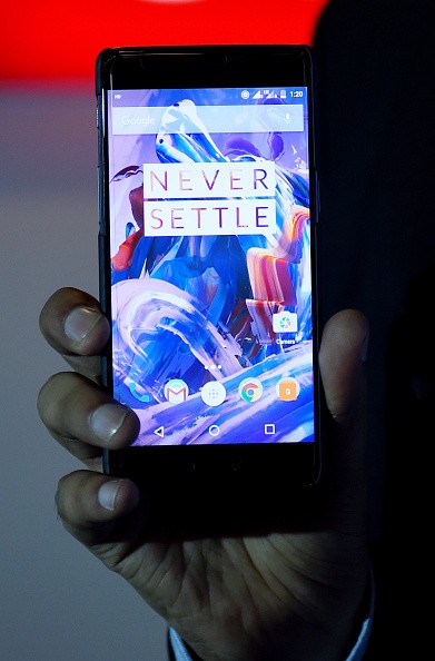 Vikas Agarwal, General Manager for Indian of the OnePlus cellphone company holds a newly-launched OnePlus 3 mobile at an event in New Delhi on June 15, 2016.