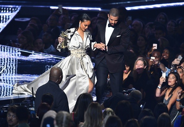 Drake escorts Rihanna after presenting her with The Video Vanguard Award during the 2016 MTV Video Music Awards.
