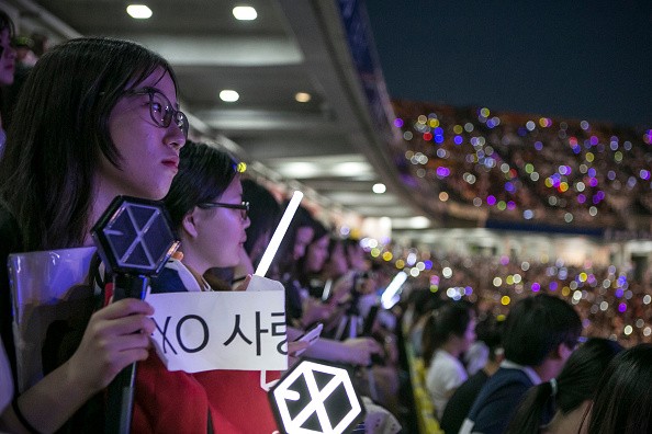 EXO-Ls hold their anticipation for the performance of their favorite idols during a concert in Korea.
