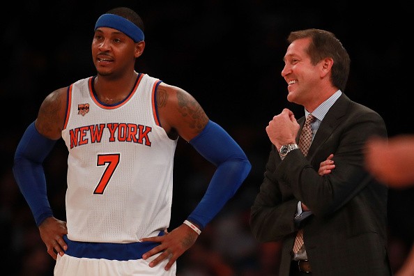 Carmelo Anthony of the New York Knicks laughs on the sideline with head coach Jeff Hornacek in the preseason game at Madison Square Garden on October 10, 2016 in New York City. 