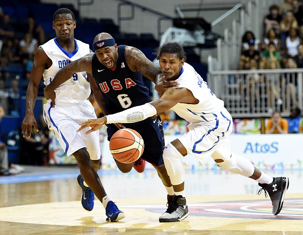 Bobby Brown  of the United States chases after a ball between Andres Feliz and Edward Santana of the Dominican Republic in a 87-82 United States win  on July 25, 2015 in Toronto, Canada. 