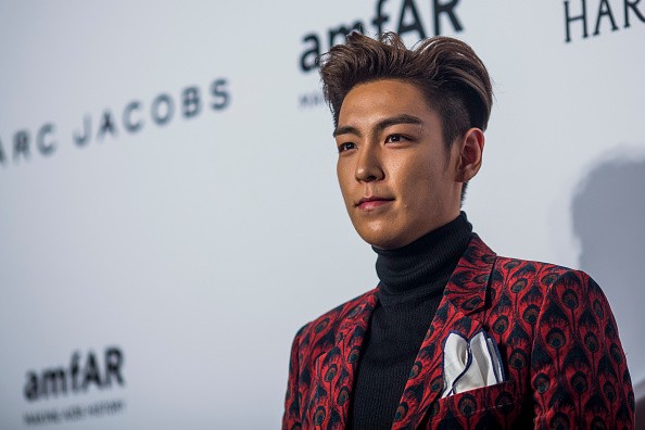 Singer T.O.P arrives on the red carpet during the 2015 amfAR Hong Kong gala