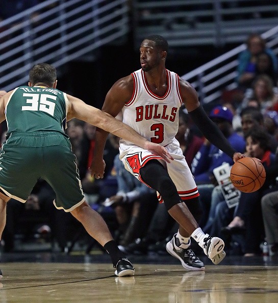 Dwyane Wade of the Chicago Bulls moves around Mirza Teletovic of the Milwaukee Bucks during a preseason game at the United Center on October 3, 2016 in Chicago, Illinois. 