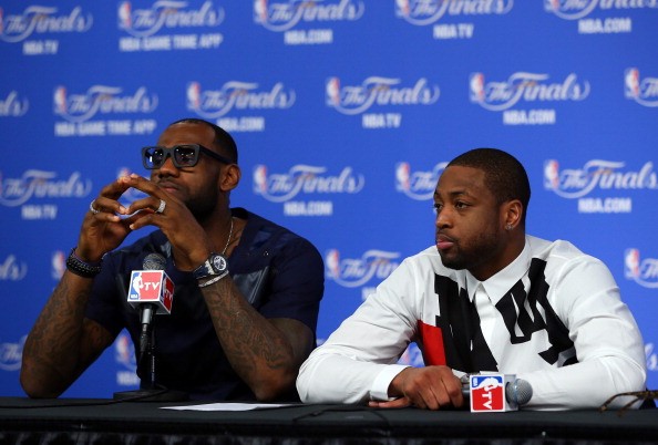 LeBron James (L) and Dwyane Wade of the Miami Heat speak to the media following a 104-87 loss in Game Five of the 2014 NBA Finals at the AT&T Center on June 15, 2014 in San Antonio, Texas. 