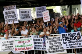 Filipino members of the Iglesia ni Cristo (Church of Christ) or INC display signs during a protest in Manila August 29, 2015.