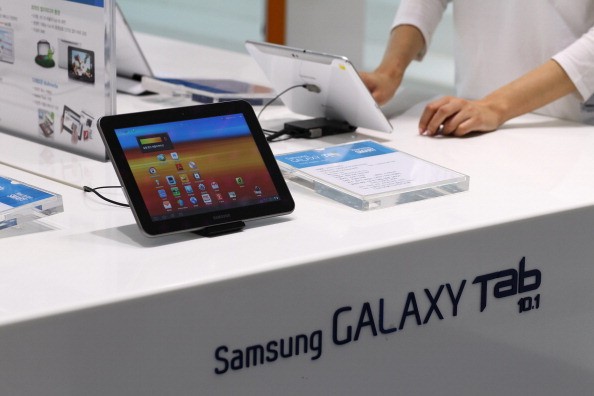 A visitor tries out a Samsung Electronics Co. Galaxy Tab 10.1 tablet computer at the company's Galaxy Zone showroom in Seoul, South Korea, on Friday, Jan. 6, 2012. Samsung, Asia's largest consumer-electronics company, reported a record quarterly profit on