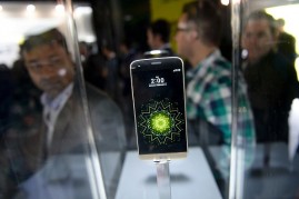 Visitors look at the new LG G5 model of South Korean multinational conglomerate corporation LG after its presentation on the eve of the official start of the Mobile World Congress in Barcelona on February 21, 2016. 