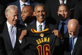 President Barrack Obama holding the Cavaliers' present - a number 16 jersey - during the team's visit to the White House.