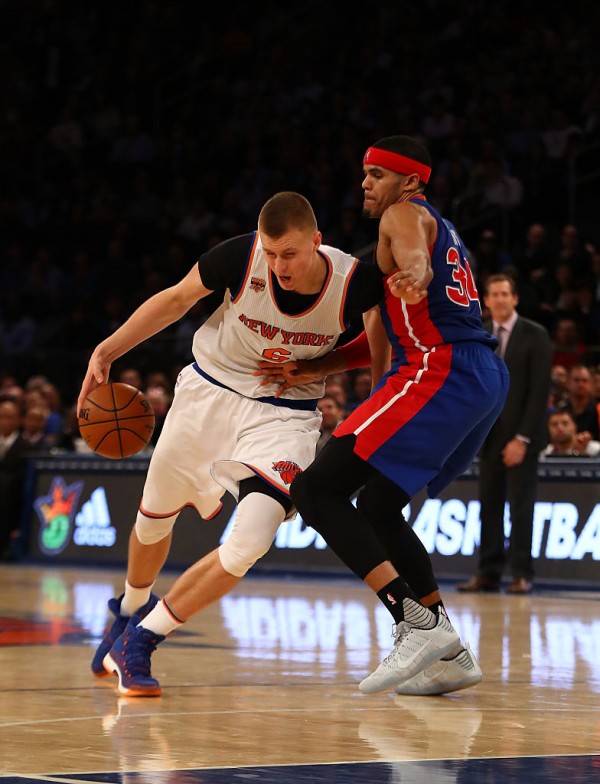 New York Knicks power forward Kristaps Porzingis (L) drives past Detroit Pistons' Tobias Harris
