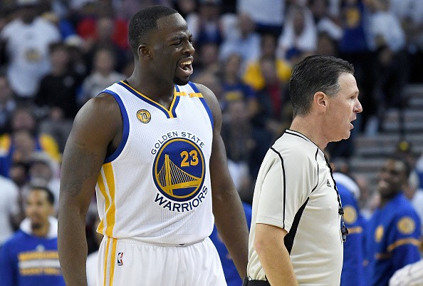 Draymond Green #23 of the Golden State Warriors complains to official Pat Fraher #26 after Fraher called a technical foul on Green against the San Antonio Spurs during the third quarter in an NBA basketball game at ORACLE Arena on October 25, 2016 Oakland