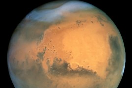 This image was taken 26 June 2001 when Mars was 68 million kilometres from Earth. The Martian summer in the northern hemisphere results in a large south polar ice cap (white, bottom).