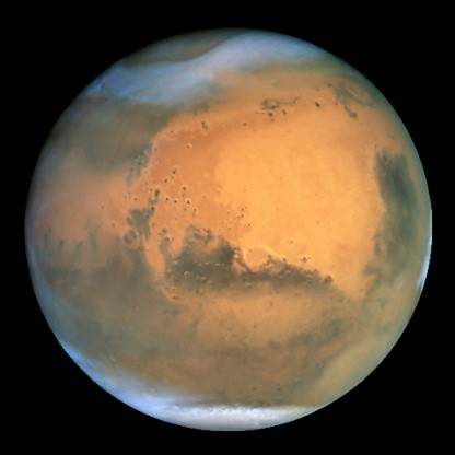 This image was taken 26 June 2001 when Mars was 68 million kilometres from Earth. The Martian summer in the northern hemisphere results in a large south polar ice cap (white, bottom).