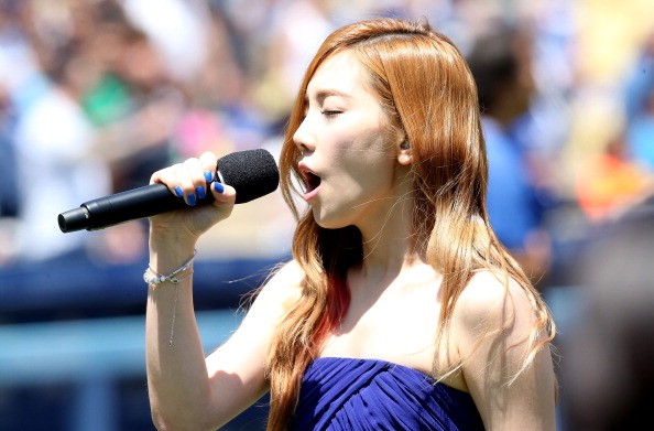 Girls' Generation's Taeyeon sings the Korean national anthem before a game between Cincinnati Reds and Los Angeles Dodgers.