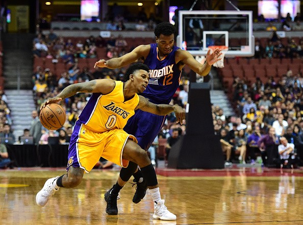 Nick Young #0 of the Los Angeles Lakers dribbles around T.J. Warren #12 of the Phoenix Suns during a preseason game at Honda Center on October 21, 2016 in Anaheim, California. 