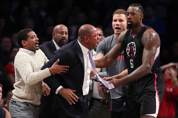 Head coach Doc Rivers of the Los Angeles Clippers is held back by DeAndre Jordan #6 and Blake Griffin #32 after a technical foul call against the Brooklyn Nets in overtime at Barclays Center on November 29, 2016 in the Brooklyn borough of New York City.  