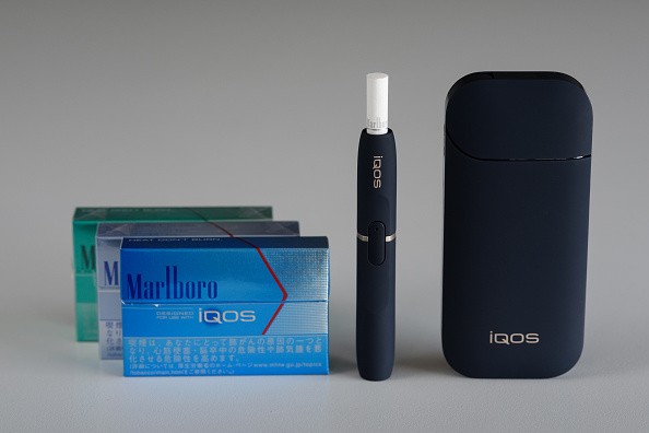 The Philip Morris International Inc. iQOS electronic cigarette, including packs of Marlboro HeatStick, left, is arranged to photograph in Tokyo, Japan, on Tuesday, Aug. 23, 2016.