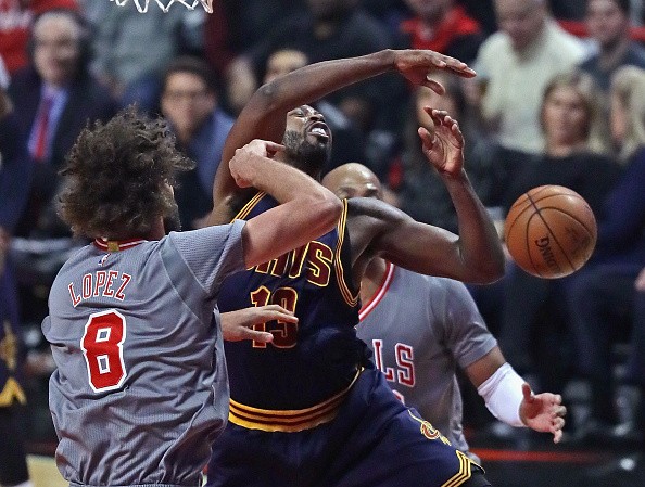 Tristan Thompson #13 of the Cleveland Cavaliers is fouled by Robin Lopez #8 of the Chicago Bulls at the United Center on December 2, 2016 in Chicago, Illinois. 